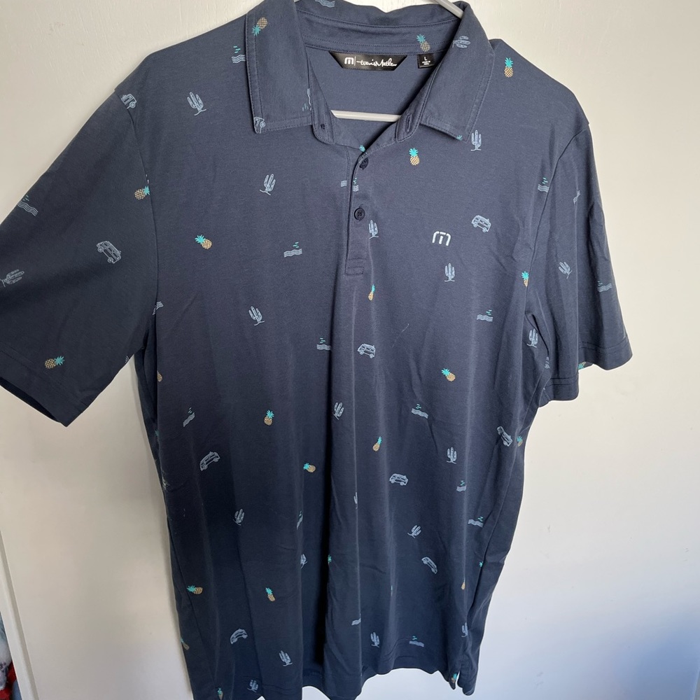Navy Travis Matthew Golf shirt with pineapples